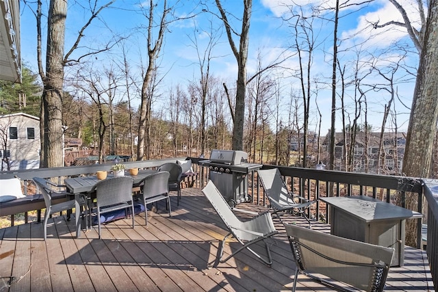 deck with outdoor dining area and grilling area