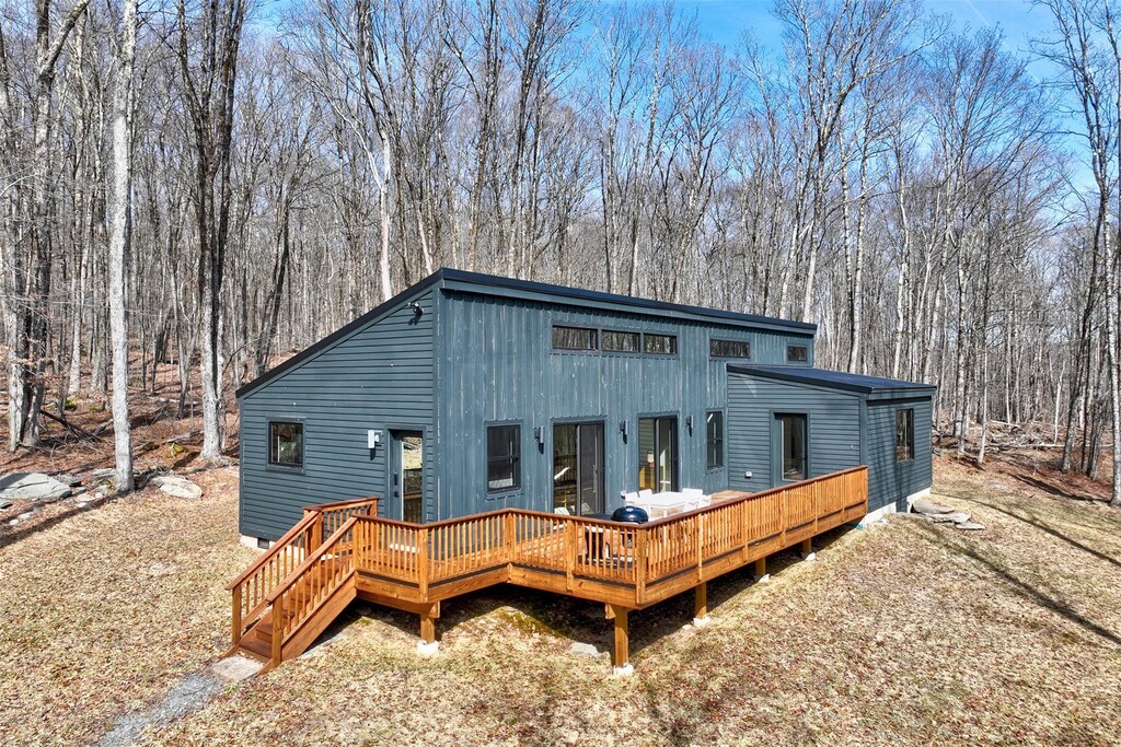 back of house featuring a wooden deck