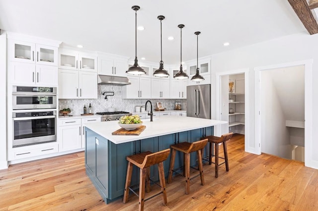 2054 Rte 6 Unit 7, Carmel, NY 10512 - kitchen featuring under cabinet range hood, stainless steel appliances, decorative backsplash, light countertops, and recessed lighting