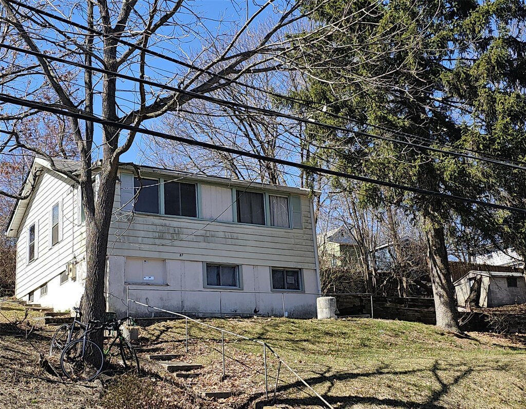 view of property exterior featuring a lawn