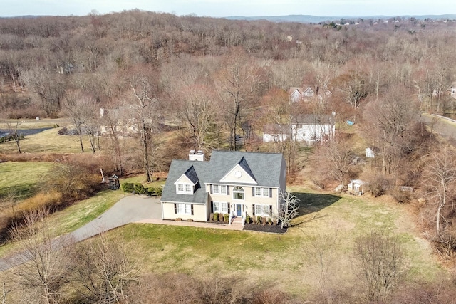 bird's eye view featuring a wooded view