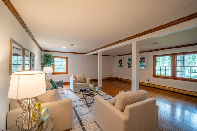 10 Hickory Ln, Glen Cove, NY 11542 - living room with ornamental molding, wood finished floors, healthy amount of natural light, a baseboard heating unit, and baseboards
