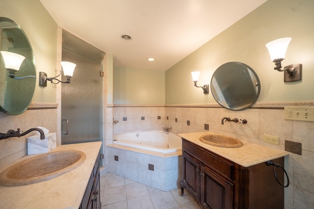 10 Hickory Ln, Glen Cove, NY 11542 - bathroom featuring tile walls, tile patterned flooring, a stall shower, a bath, and two vanities