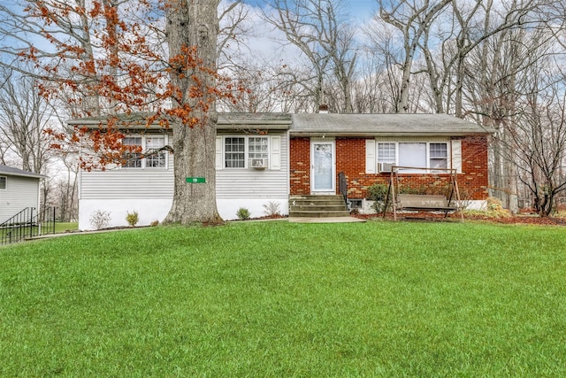 ranch-style home with brick siding, a front yard, and entry steps