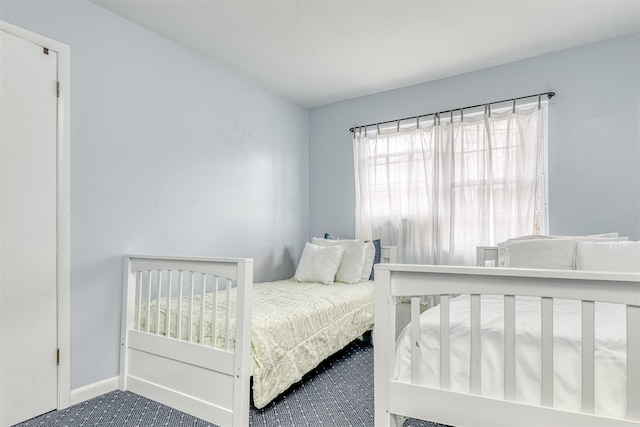 bedroom with baseboards and carpet flooring