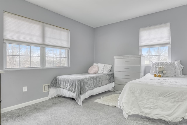 bedroom with baseboards, carpet flooring, and visible vents