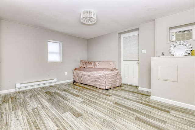 unfurnished room featuring a baseboard radiator, baseboards, and light wood-type flooring