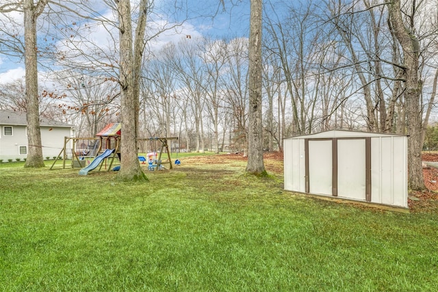 view of yard with a storage unit, an outbuilding, and a playground