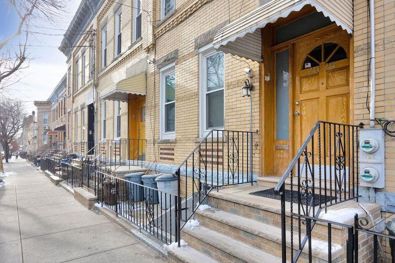 doorway to property featuring brick siding