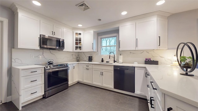 kitchen with white cabinets, glass insert cabinets, stainless steel appliances, and a sink