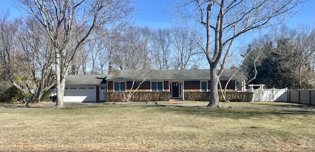 single story home with a chimney, an attached garage, fence, and a front lawn