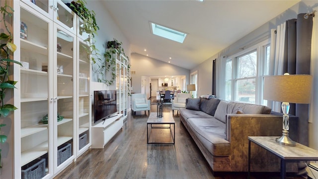 living room with dark wood finished floors and lofted ceiling with skylight