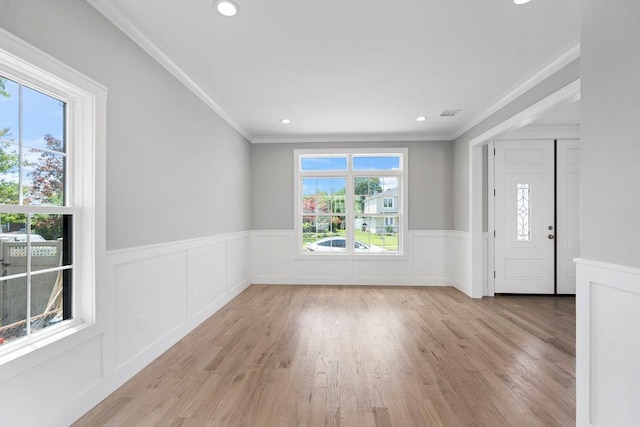 407 Wellington Rd, East Meadow, NY 11554 - entrance foyer with a wainscoted wall, ornamental molding, light wood-style floors, and recessed lighting