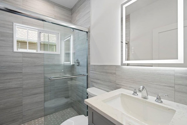 407 Wellington Rd, East Meadow, NY 11554 - full bathroom featuring toilet, a shower stall, vanity, and tile walls