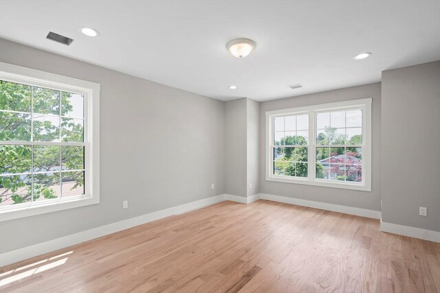 407 Wellington Rd, East Meadow, NY 11554 - empty room featuring healthy amount of natural light, baseboards, light wood-type flooring, and recessed lighting