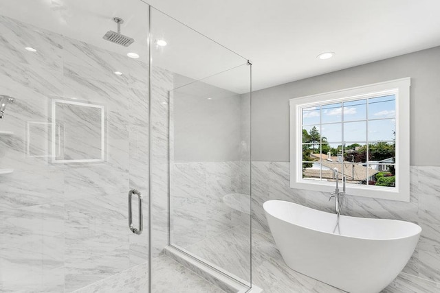 407 Wellington Rd, East Meadow, NY 11554 - full bathroom with a marble finish shower, a freestanding bath, tile walls, a wainscoted wall, and marble finish flooring