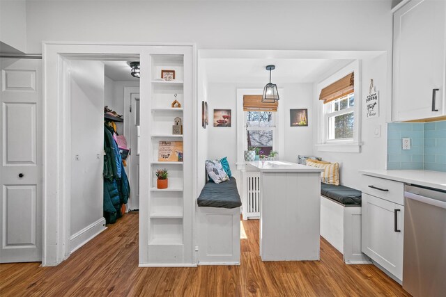 kitchen featuring light wood finished floors, white cabinets, and dishwasher