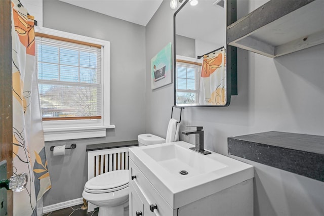 full bathroom with baseboards, toilet, and vanity