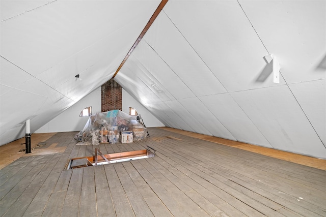 bonus room featuring lofted ceiling and hardwood / wood-style flooring