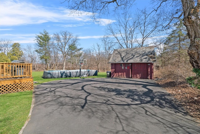 view of street featuring aphalt driveway