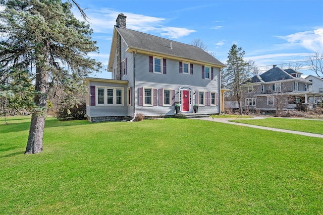 colonial home with a chimney and a front lawn