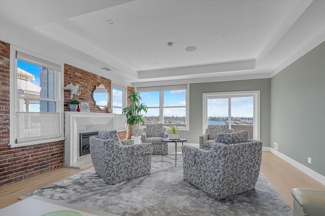 31 Casino St Ph, Ph, Freeport, NY 11520 - living area with baseboards, brick wall, and a raised ceiling