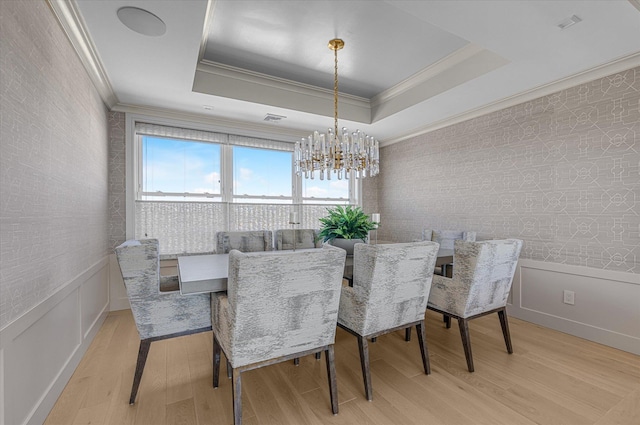 31 Casino St Ph, Ph, Freeport, NY 11520 - dining area with a tray ceiling, light wood-style flooring, a chandelier, and wainscoting