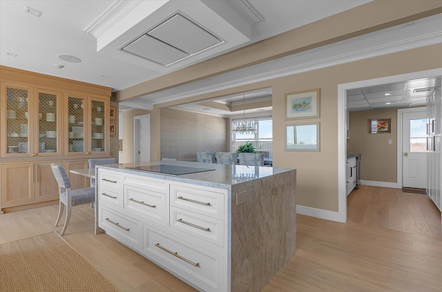 31 Casino St Ph, Ph, Freeport, NY 11520 - kitchen featuring black electric cooktop, white cabinetry, light wood-style floors, and glass insert cabinets