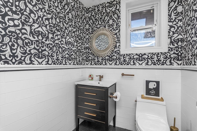 31 Casino St Ph, Ph, Freeport, NY 11520 - bathroom featuring tile walls, vanity, toilet, and wainscoting