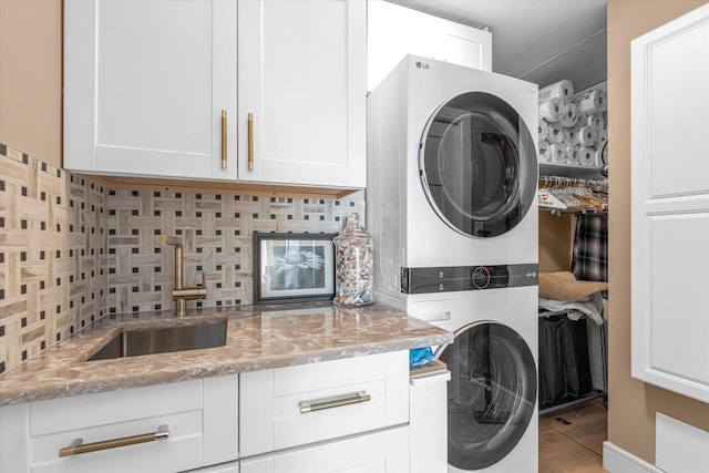 31 Casino St Ph, Ph, Freeport, NY 11520 - clothes washing area featuring stacked washer and clothes dryer and cabinet space