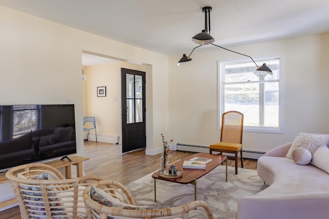living area featuring baseboards and wood finished floors