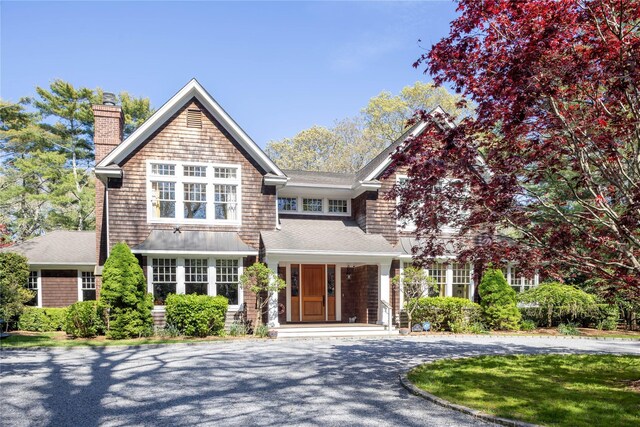 53 Cedar Ln W, Remsenburg, NY 11960 - shingle-style home featuring a chimney, curved driveway, a shingled roof, and covered porch
