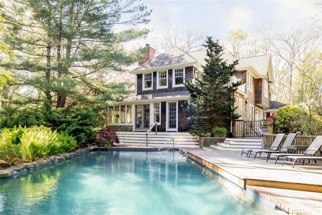 53 Cedar Ln W, Remsenburg, NY 11960 - rear view of house with an outdoor pool, a patio, a chimney, and roof with shingles