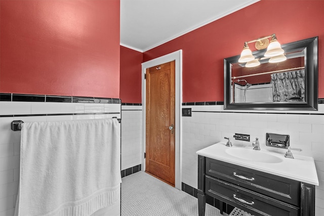 bathroom featuring ornamental molding, tile walls, wainscoting, and vanity