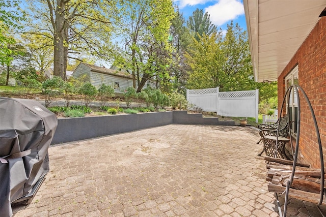 view of patio / terrace featuring fence and grilling area