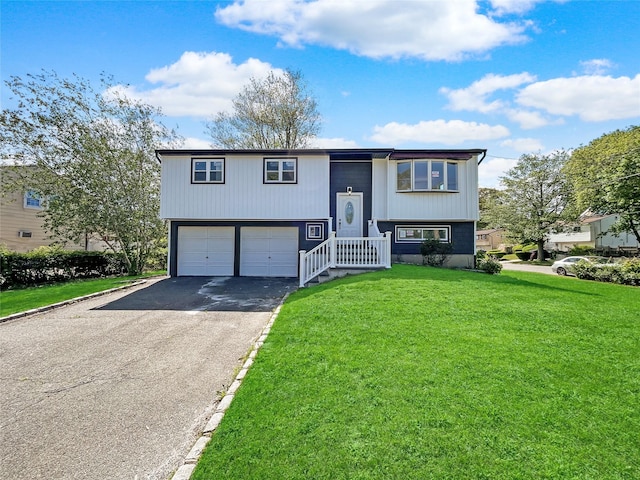 1580 Brentwood Rd, Bay Shore, NY 11706 - bi-level home featuring driveway, a front yard, and an attached garage