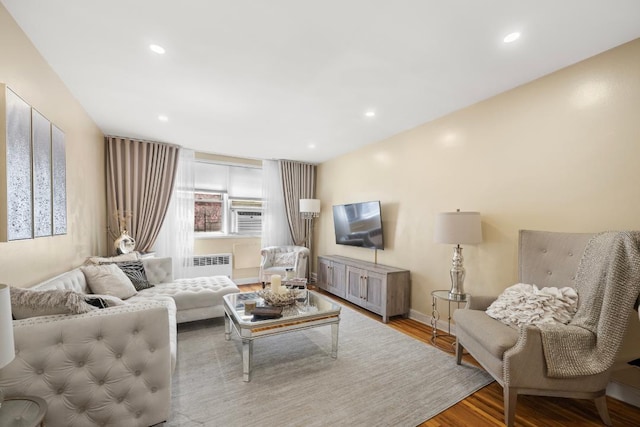 65-65 Wetherole St Unit 1N, Rego Park, NY 11374 - living room featuring recessed lighting, radiator heating unit, wood finished floors, and baseboards