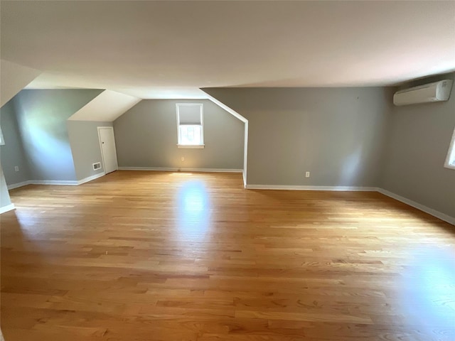 26 Alden Rd, Poughkeepsie, NY 12603 - bonus room with a wall mounted air conditioner, light wood-type flooring, and lofted ceiling