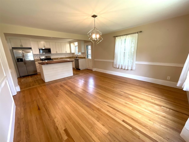 26 Alden Rd, Poughkeepsie, NY 12603 - kitchen featuring appliances with stainless steel finishes, a chandelier, and light wood finished floors