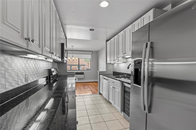 kitchen featuring beverage cooler, recessed lighting, a sink, backsplash, and stainless steel appliances