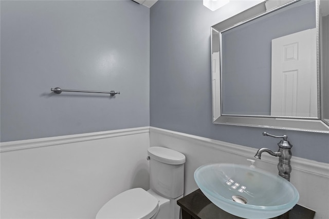half bath featuring a sink and toilet