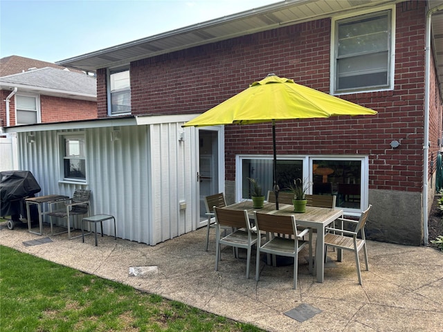 164-33 97th St, Howard Beach, NY 11414 - rear view of property with a patio, outdoor dining area, and brick siding