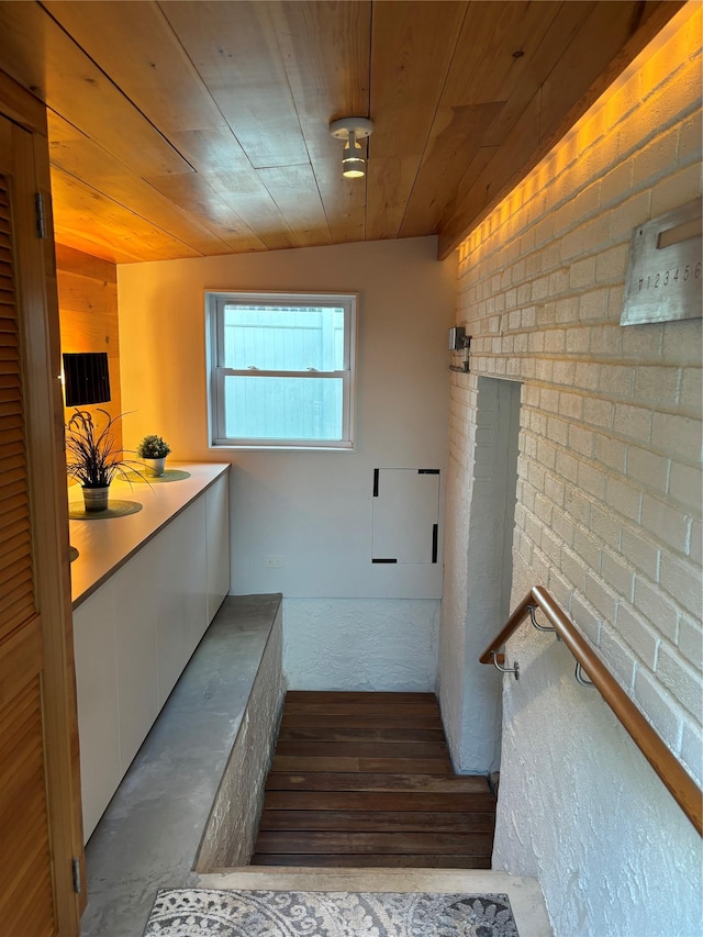 164-33 97th St, Howard Beach, NY 11414 - stairway with wooden ceiling, wood finished floors, and brick wall