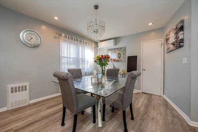 1075 Frances Dr, Valley Stream, NY 11580 - dining area with a wall mounted air conditioner, a chandelier, light wood-style floors, radiator, and recessed lighting