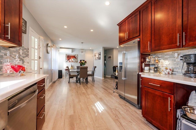 1075 Frances Dr, Valley Stream, NY 11580 - kitchen featuring stainless steel appliances, decorative backsplash, light countertops, recessed lighting, and light wood-type flooring