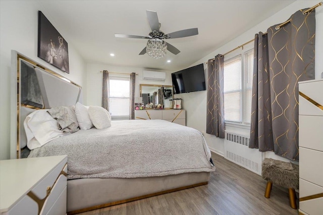 1075 Frances Dr, Valley Stream, NY 11580 - bedroom featuring radiator heating unit, an AC wall unit, wood finished floors, recessed lighting, and a ceiling fan
