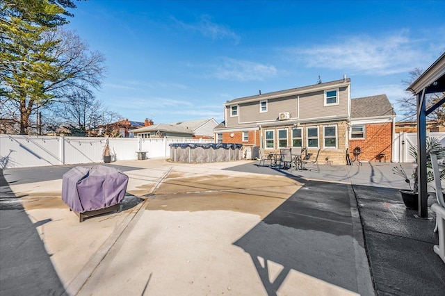 1075 Frances Dr, Valley Stream, NY 11580 - back of house featuring a patio area, a fenced backyard, a gate, brick siding, and outdoor dining area