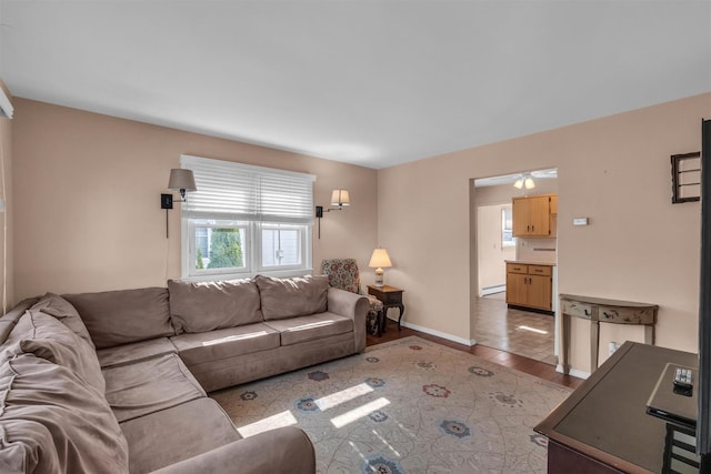 living room featuring light wood-type flooring, baseboards, and baseboard heating