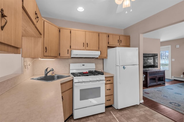 kitchen featuring ceiling fan, under cabinet range hood, light countertops, white appliances, and a sink