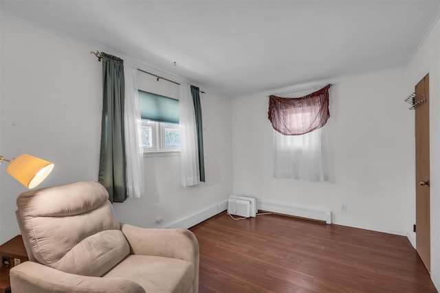 living area with wood finished floors, baseboards, and ornamental molding